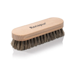 A Renapur branded horsehair polishing and cleaning brush with a wooden handle and dark bristles, for gentle care of leather, suede, and fabric.
