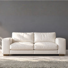 White leather sofa sitting in a front room