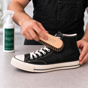 Gently brushing protector into a black canvas trainer with a Renapur Horsehair Brush.