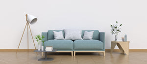 Pale blue fabric sofa with cushions in a bright living room.