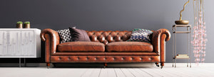 Brown leather sofa being cared for with leather conditioner
