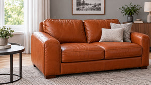 A brown leather sofa left to dry naturally after cleaning in a softly lit living room.