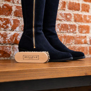 Renapur Horsehair Brush with the framed Renapur logo in front of navy suede boots against a brick wall.