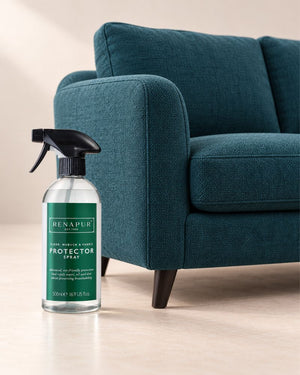 Renapur 500ml Protector Spray beside a teal fabric sofa.