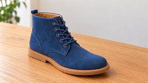 Blue suede boot left to dry on a wooden table after applying protector.
